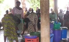 Eating food prepared by the health committee in Nano, Africa